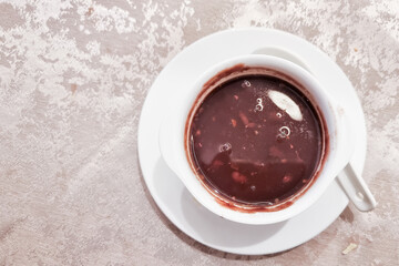 Overhead view of a bowl serving of red bean soup, popular desert among Asian Chinese