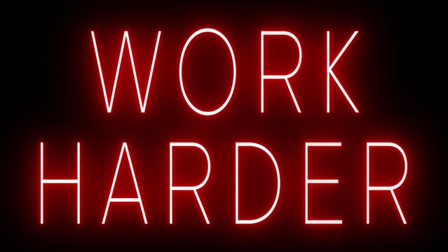 Flickering red retro style neon sign glowing against a black background for WORK HARDER