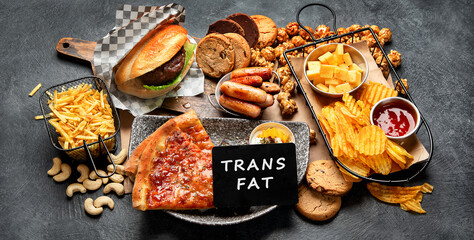 Fast food on a dark background. Junk food for your heart and skin. Trans fat concept