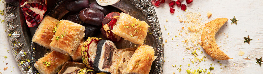 Traditional middle eastern sweets assortment with ramadan decor. Ramadan desserts.