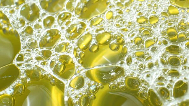 In this macro video, urine exhibits pronounced foam formation, possibly indicating elevated protein levels or renal issues, warranting medical evaluation. Body fluid concept. 4K.
