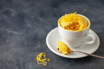 Lemon cupcake in a white mug. Easy homemade dessert. Mug cake