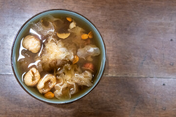 Serving of longan with snow fungus goji seaweed soup in bowl, popular desert among the Chinese