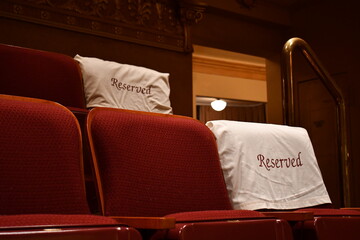 Reserved seating covers on theater seats.