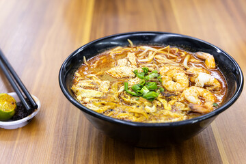 No frills simple but delicious Sarawak laksa noodle soup served with shrinps in hawker stall