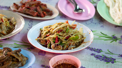Papaya salad with crab, fermented fish, cockle, Thai food in a Thai dish
