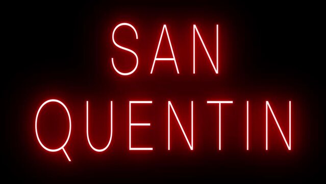 Flickering red retro style neon sign glowing against a black background for SAN QUENTIN