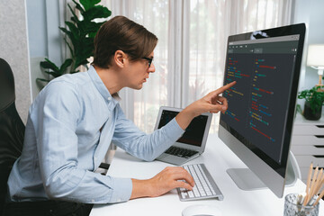 IT developer selecting by point on coding online software development information on pc comparing...
