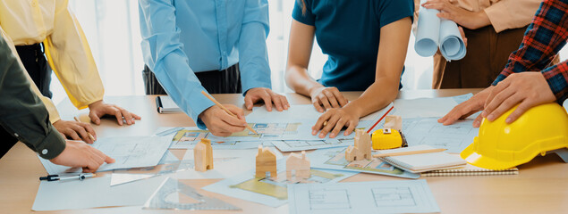 Professional architect engineer team discussion about architectural project on meeting table with...