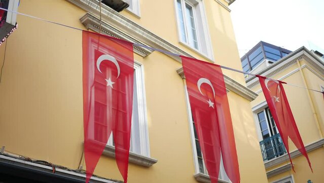 A low angle shot of Turkish national flag hanging on a rope in the street