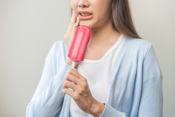 Face expression suffering from sensitive teeth and cold, asian young woman, girl hand touching...