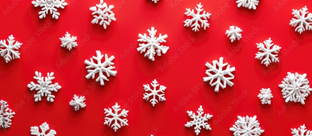 Poster minimal new year pattern with red background and snowflakes in a flat lay.