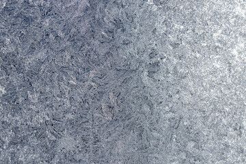 Full frame macro abstract texture background of an ice frosted glass window pane in a color shade of pearl white, with copy space
