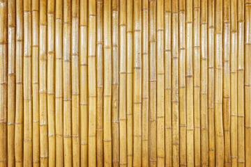 Schilderijen op glas vertical yellow bamboo wall,dry bamboo texture exactly vertically straight wall floor light. Eco natural background concept © prapann