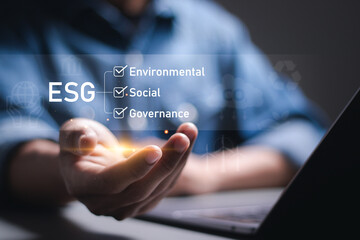 Businessman holding virtual global ESG icons for world sustainable environment concept. social...