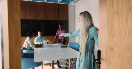 Attractive friendly businesslady, company boss invites new employee to meeting room, welcoming vacancy applicant, start job interview in modern boardroom. Newcomer and first workday, human resources