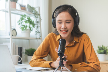 Podcast concept asian young woman radio host work with headphones, microphone while talk,...