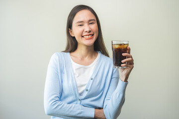 Thirsty, attractive asian young woman, happy girl drink or sip, holding a glass of cold sparkling...