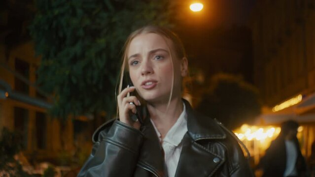 Caucasian european angry woman showing hand watch talking mobile phone smartphone call dissatisfied female emotions late meet quarrel scream city outside evening problem conflict time wait blame gen z