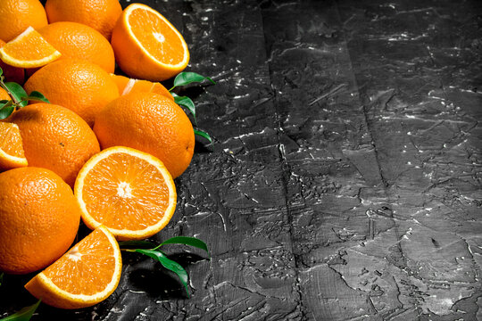 Pieces of oranges with leaves.
