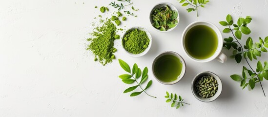 Moringa tea arranged creatively on a white surface in a flat lay style, showcasing food and macro...