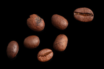 Coffee beans isolated on black background. Close-up