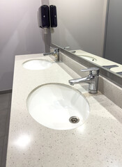 White washbasin with tap in the restroom