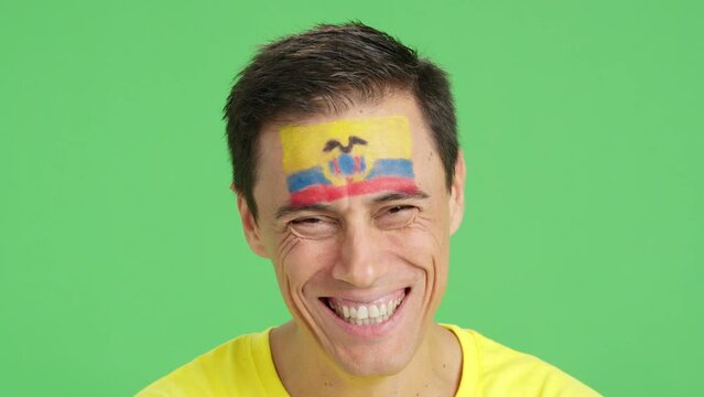 Man with a ecuadorian flag painted on the face smiling