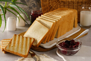 sliced toast bread toasted with cranberry jam