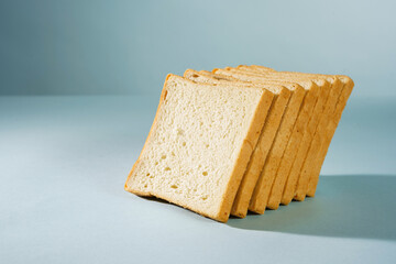 bread for toast cut into slices, on a blue background