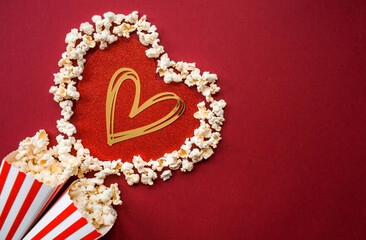 A banner for the film industry. A romantic movie date. A popcorn heart and retro striped cups on a...