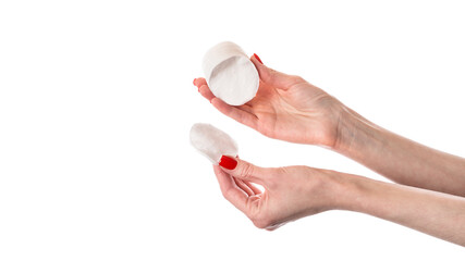 Woman holding cotton pads isolated on white background. Cotton pads in female hand with red nails.