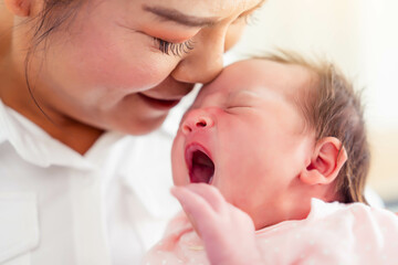 Pretty mother woman holding newborn baby in her arms Newborn baby yawn and feel sleepy