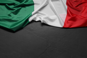 Flag of Italy on black background, top view. Space for text