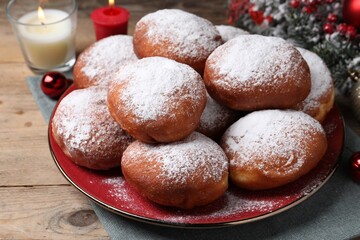 Delicious sweet buns and burning candles on table, closeup