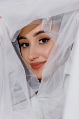 Close up portrait of a young woman casual portrait in a positive way, big smile, beautiful model posing in the studio on a white background. Caucasian Asian woman portrait.