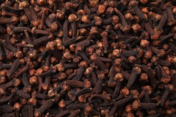 Many aromatic cloves as background, top view