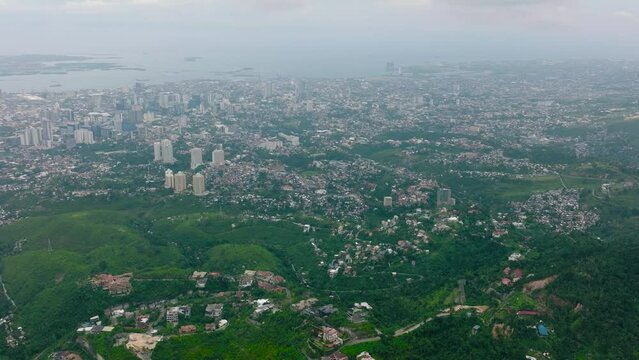Top view of city of Cebu in the Philippines with residential buildings and skyscrapers.