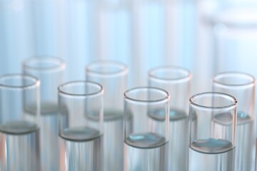 Laboratory analysis. Many glass test tubes on blurred background, closeup