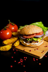 Hamburger with meat patty and cheese. bacon and fresh vegetables