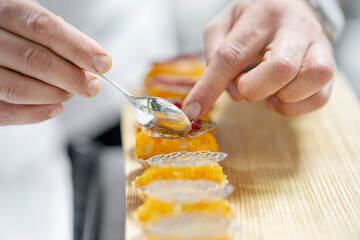 Chef Preparing Gourmet Hors d'Oeuvres with Precision in a Professional Kitchen