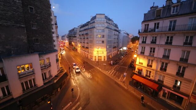 Street with cars at night in residential district in Paris, France