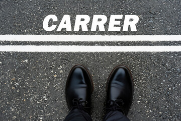 shoes on the asphalt. black leather men's shoes on the asphalt, on the road there are two white stripes with the inscription CARRER, creative concept