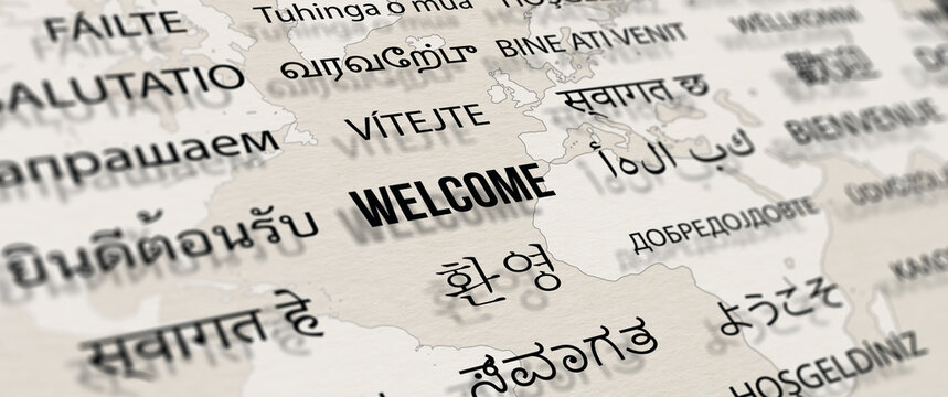 Welcome in different language on paper with world map background. Depth of field image. Words cloud concept.