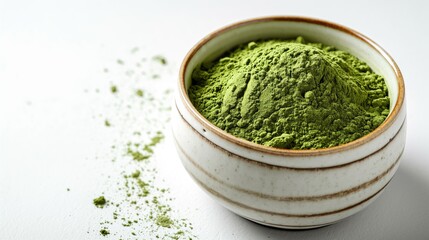 Obraz na płótnie Canvas closeup of green tea or matcha powder in a small cup isolated on a white background. 