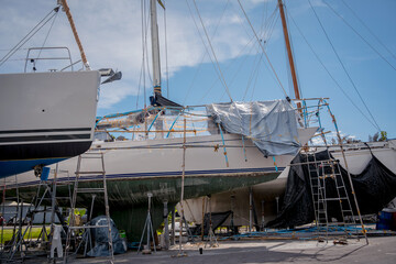 Fototapeta na wymiar Motor yacht moored for repairs and service in dry dock
