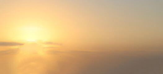 Blurry yellow light soft panorama sunset sky background with light yellow clouds