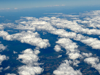 view from the plane on some scattered clouds.