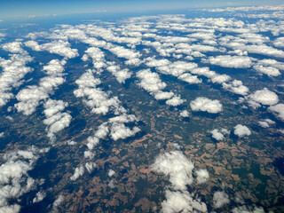 view from the plane on some scattered clouds.