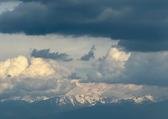 the snowy peaks of some mountains. landscape with leaden clouds.